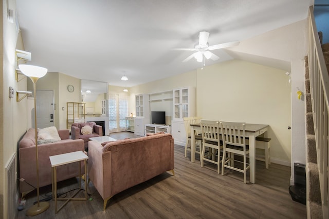 living room featuring dark wood-type flooring, ceiling fan, and lofted ceiling