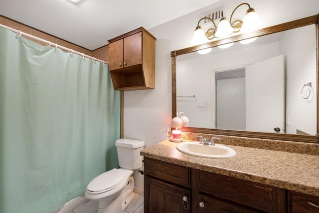 bathroom with a textured ceiling, vanity, toilet, and a shower with shower curtain