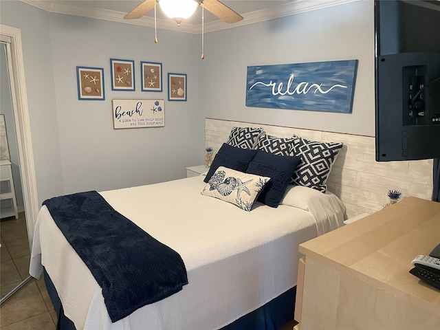 bedroom with crown molding, ceiling fan, and tile patterned floors