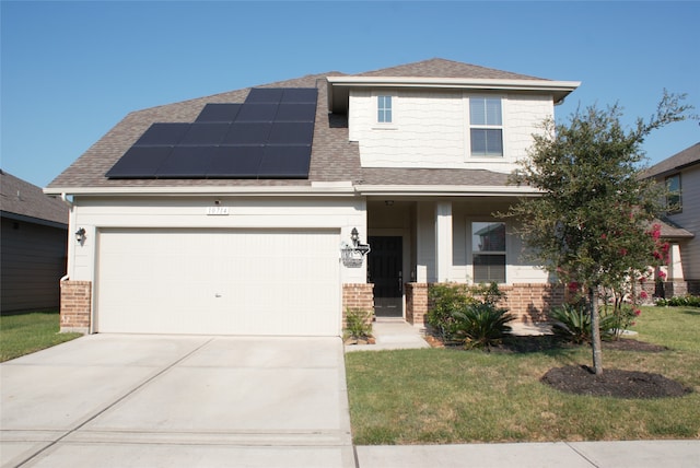 view of front of house with a garage, a front yard, a porch, and solar panels