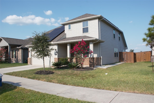 view of front facade with a front lawn, a garage, and solar panels