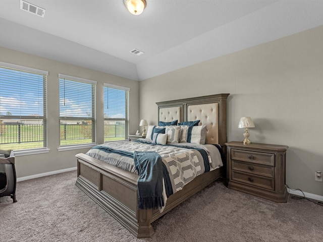 carpeted bedroom with lofted ceiling and multiple windows