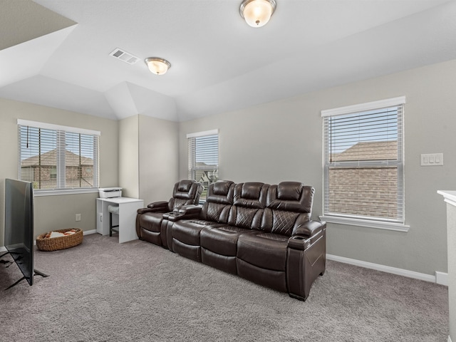 carpeted living room featuring vaulted ceiling