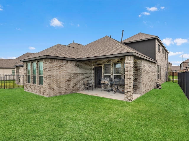 rear view of house featuring a lawn and a patio area