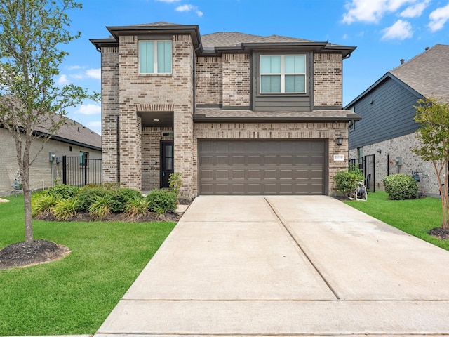 view of front of property with a garage and a front yard