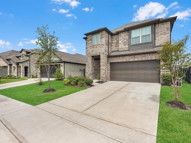 view of front of home with a front lawn and a garage