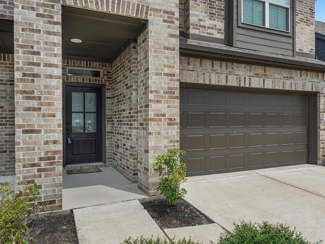 doorway to property with a garage