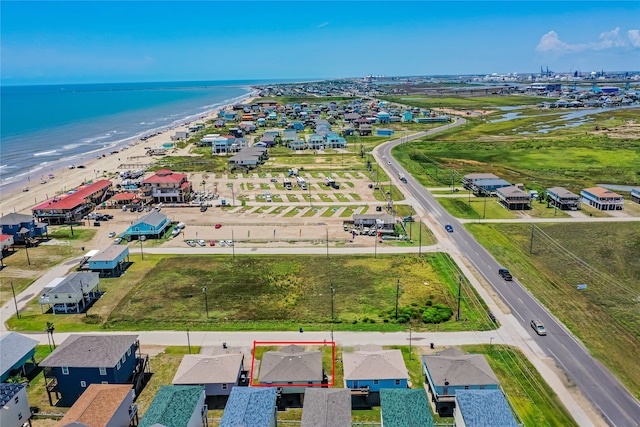 birds eye view of property featuring a view of the beach and a water view