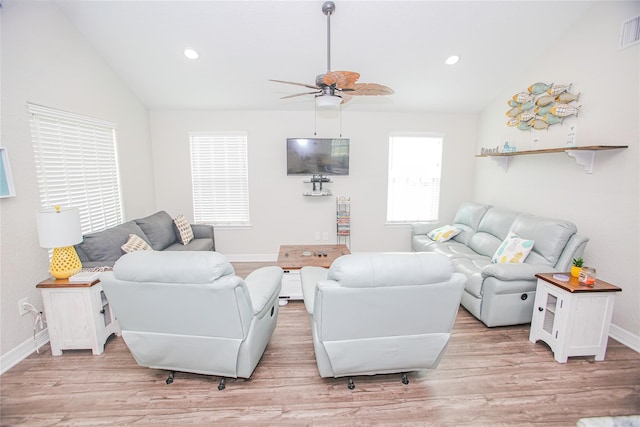 living room with light hardwood / wood-style floors, ceiling fan, and lofted ceiling