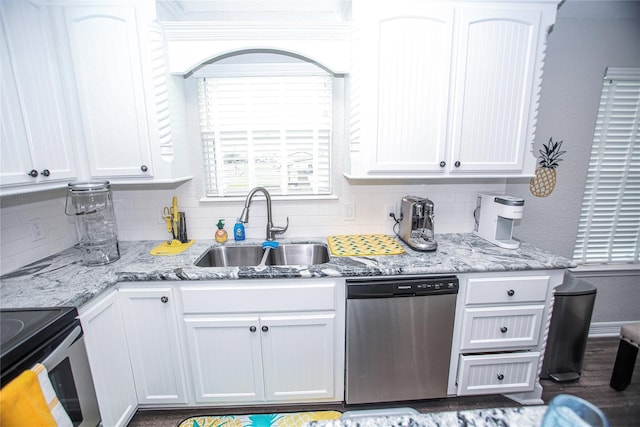 kitchen featuring stainless steel appliances, light stone countertops, white cabinets, and sink