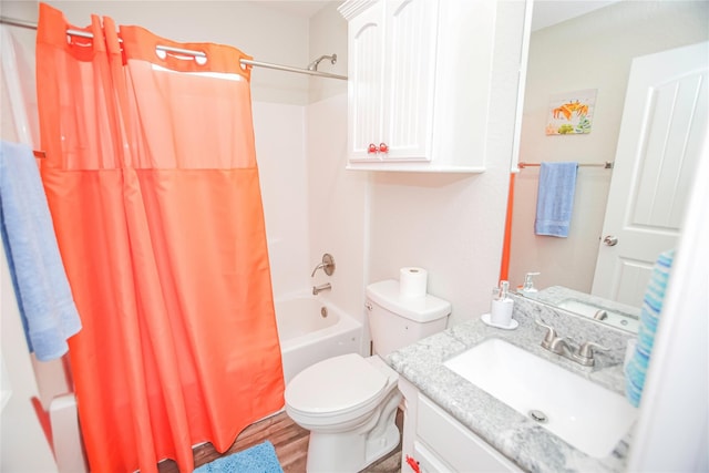 full bathroom with shower / bath combo with shower curtain, vanity, hardwood / wood-style flooring, and toilet