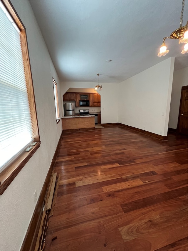 unfurnished living room featuring dark wood-type flooring