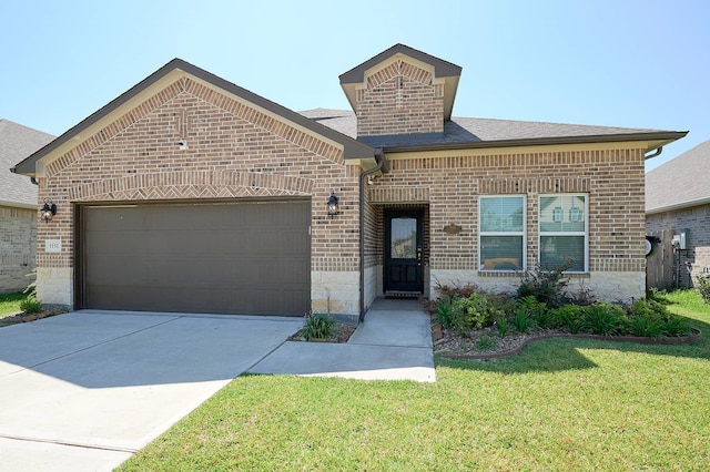 view of front of home with a front yard and a garage