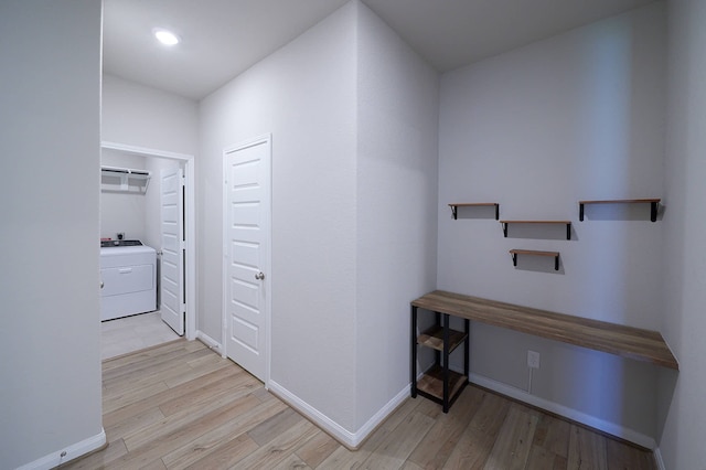 hallway featuring light wood-type flooring and washer / clothes dryer