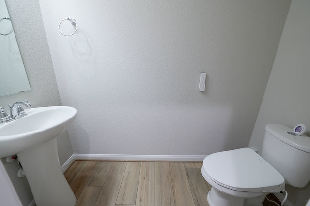 bathroom featuring toilet and hardwood / wood-style flooring