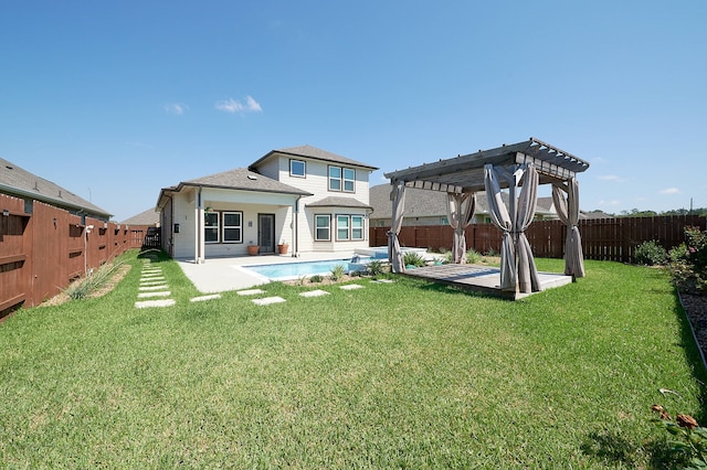 back of house with a pergola, a patio area, and a lawn