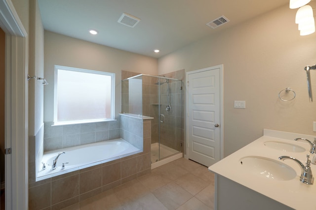 bathroom with vanity, plus walk in shower, and tile patterned flooring