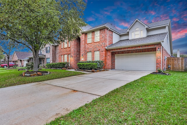 view of front facade featuring a garage and a yard