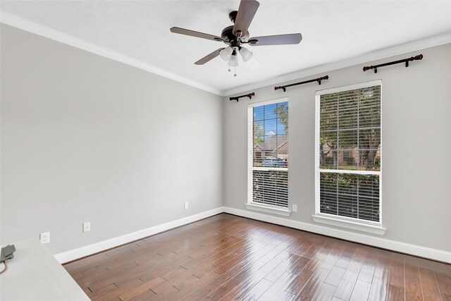 unfurnished room featuring crown molding, ceiling fan, and dark wood-type flooring