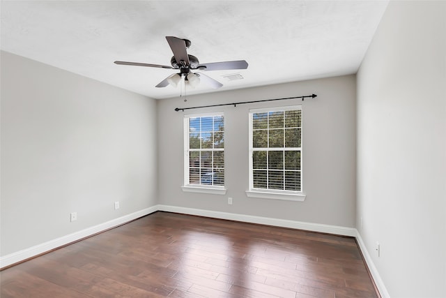 empty room featuring dark wood-type flooring and ceiling fan