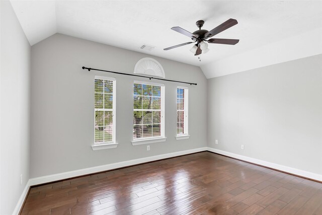 spare room with vaulted ceiling, dark hardwood / wood-style flooring, and ceiling fan