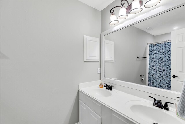 bathroom with a shower with curtain and vanity