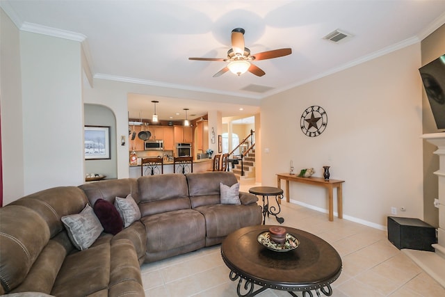 living room with ceiling fan, ornamental molding, and light tile patterned flooring