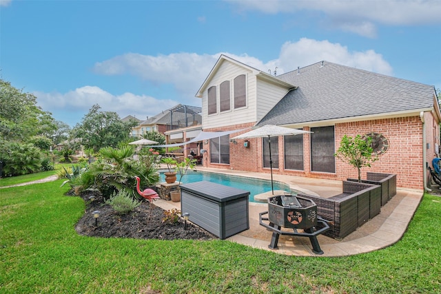 view of swimming pool featuring a patio area, a yard, and an outdoor fire pit