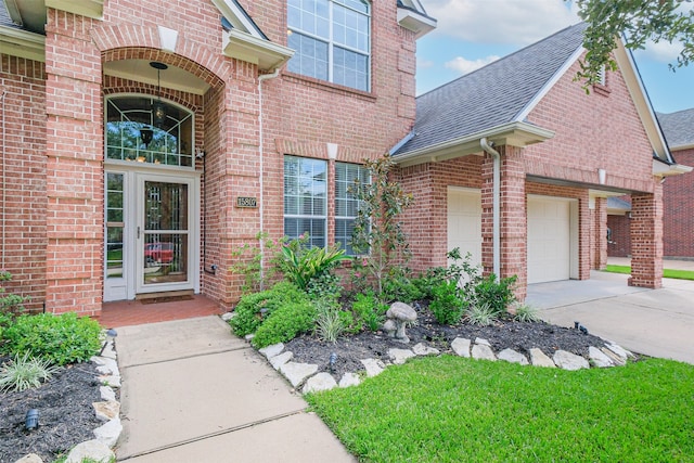 doorway to property with a garage