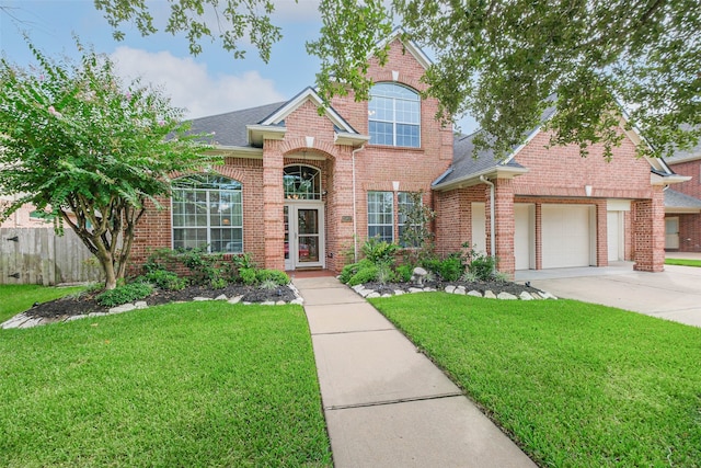 view of front property with a garage and a front yard