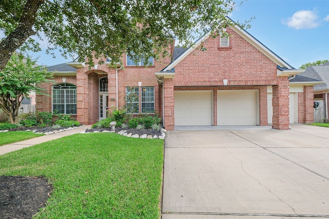 view of front of home featuring a garage and a front lawn