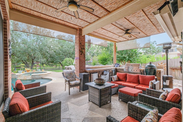 view of patio / terrace with area for grilling, ceiling fan, an in ground hot tub, and an outdoor living space