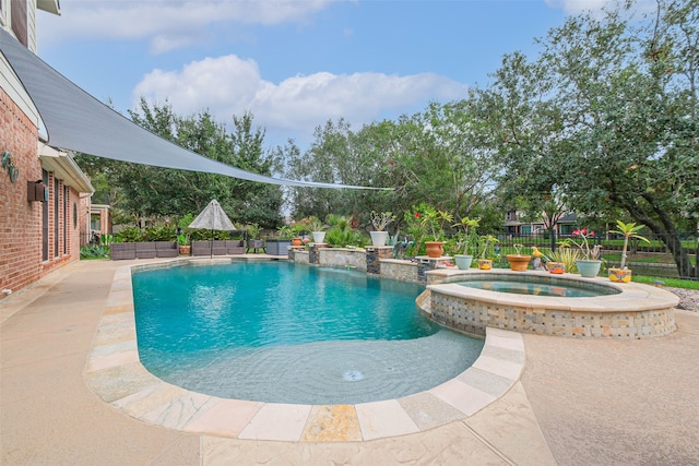 view of swimming pool featuring an in ground hot tub and pool water feature