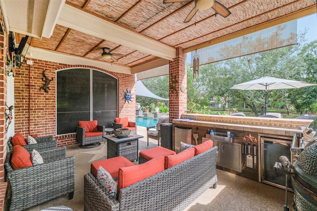 view of patio / terrace featuring outdoor lounge area, ceiling fan, and an outdoor kitchen