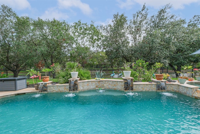 view of swimming pool with pool water feature