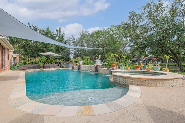 view of swimming pool with pool water feature and an in ground hot tub