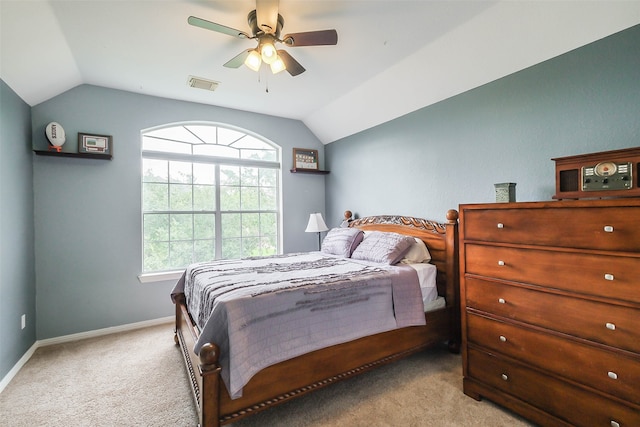 bedroom with light carpet, vaulted ceiling, and ceiling fan