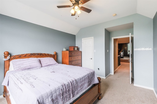 carpeted bedroom with vaulted ceiling and ceiling fan