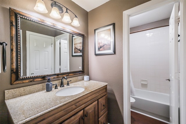 full bathroom featuring vanity, toilet, and tiled shower / bath