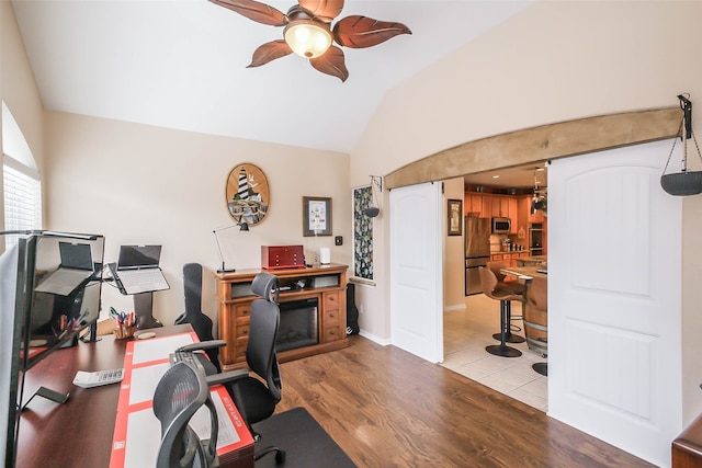 office featuring vaulted ceiling, hardwood / wood-style flooring, and ceiling fan