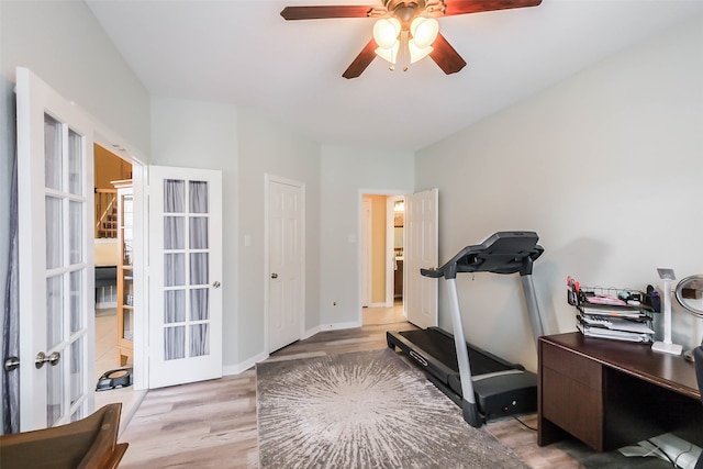 exercise room featuring french doors, hardwood / wood-style floors, and ceiling fan