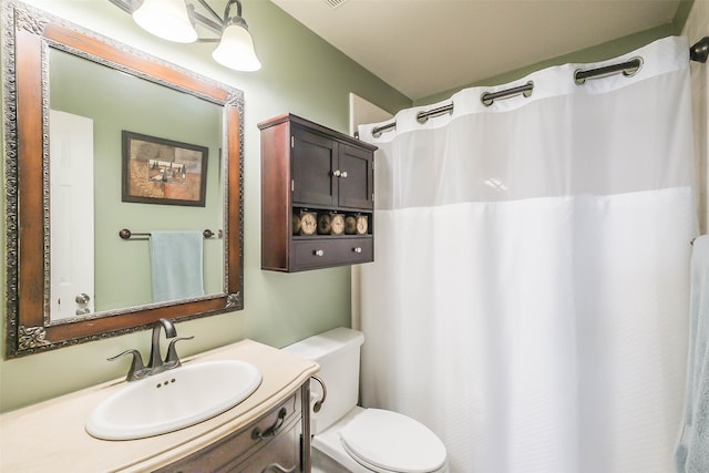 bathroom featuring vanity, toilet, and a shower with curtain