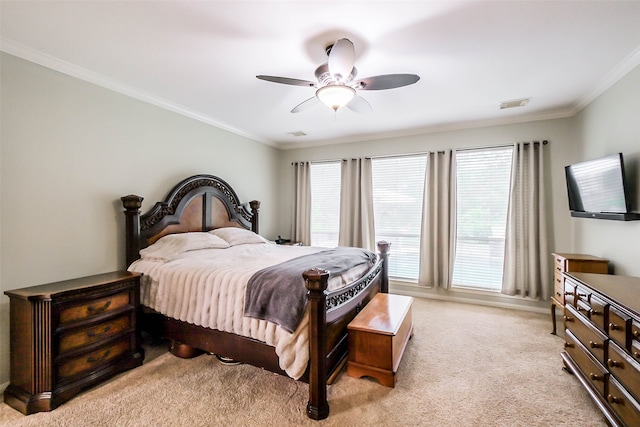 carpeted bedroom featuring ornamental molding and ceiling fan