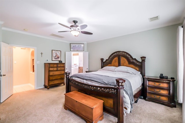 bedroom with ceiling fan, ornamental molding, light carpet, and ensuite bath