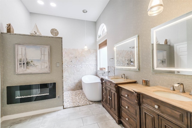 bathroom featuring a bath, tile patterned flooring, and vanity