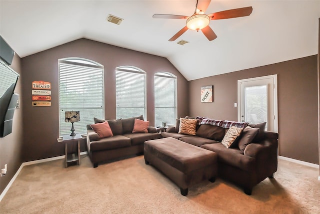 carpeted living room featuring ceiling fan and vaulted ceiling