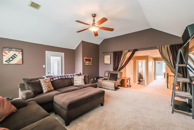 carpeted living room with ceiling fan and vaulted ceiling