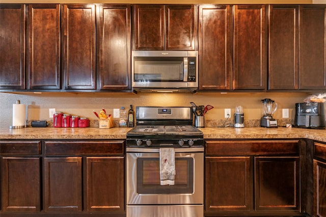 16555 Mandate Dr, Houston, TX 77049 - kitchen with light countertops, dark brown cabinets, and appliances with stainless steel finishes