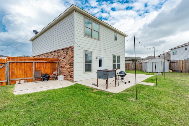 rear view of property with a storage shed, a yard, and a patio