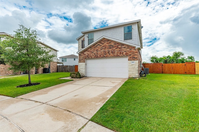 view of property featuring a front yard and a garage